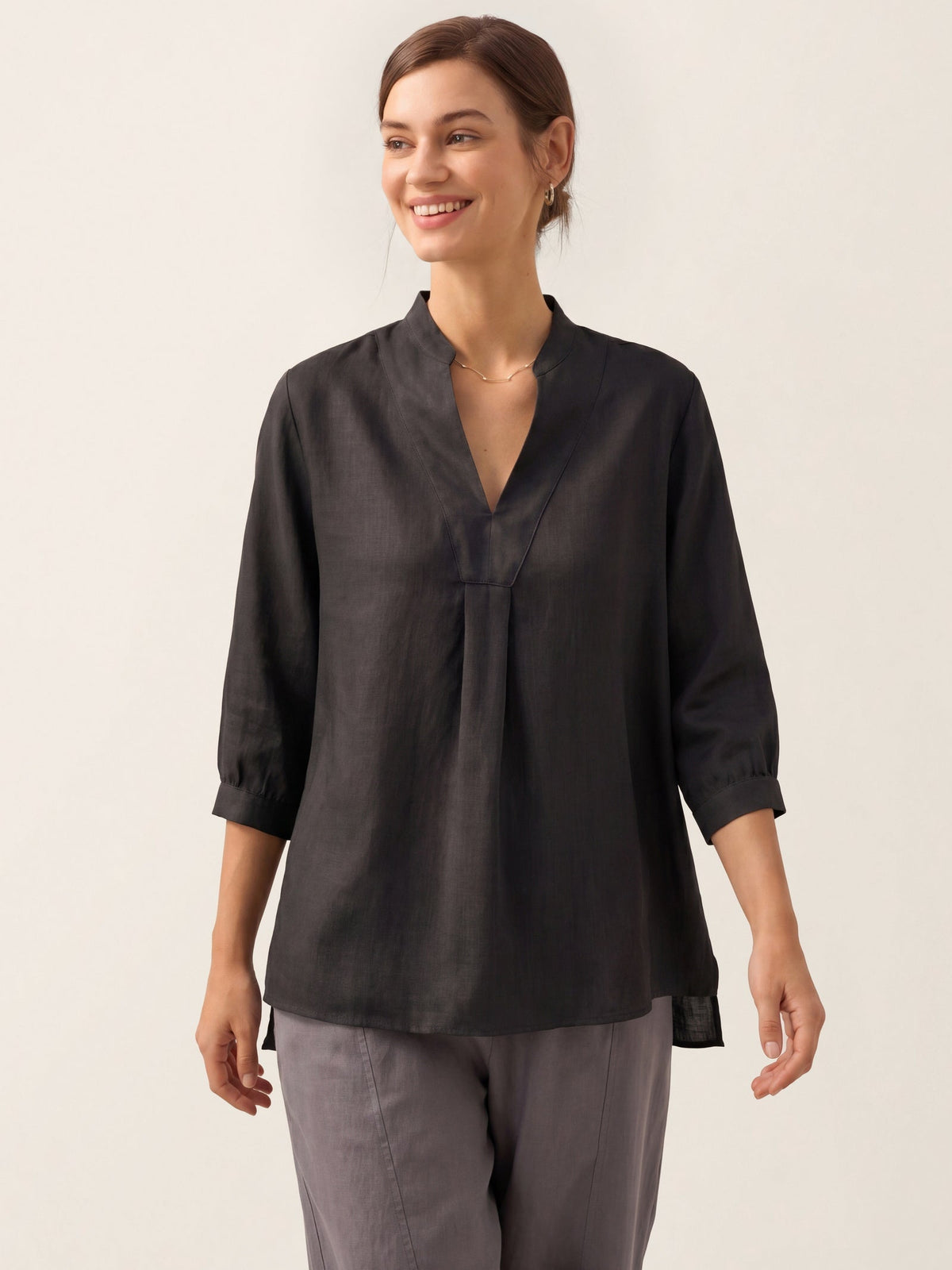 a woman smiling and wearing a black shirt