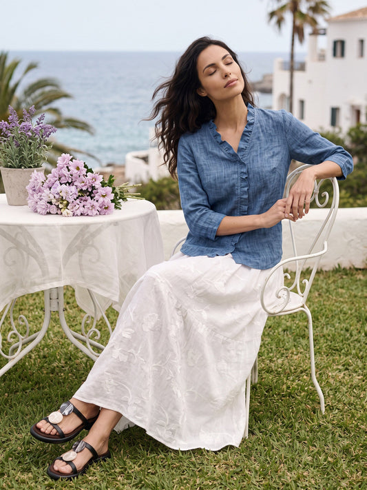 a woman sitting in a chair outside