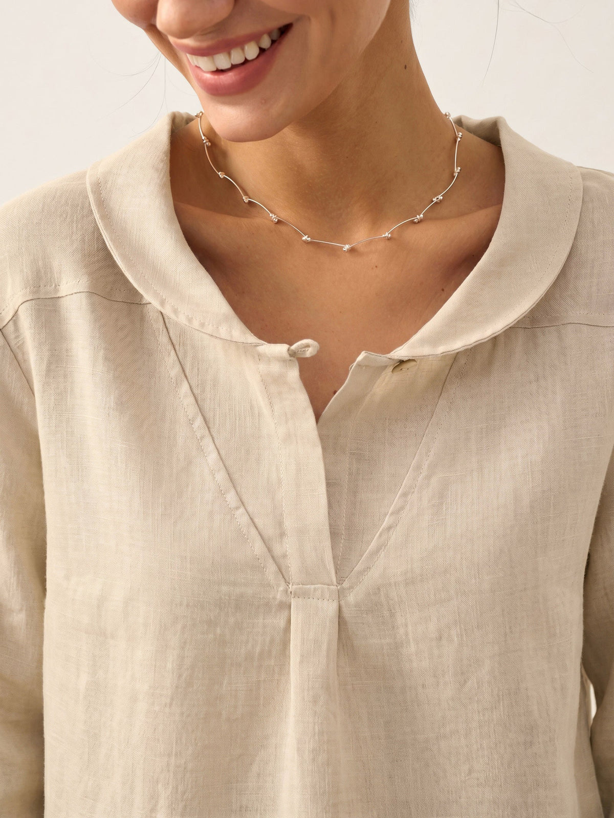 a woman wearing a necklace