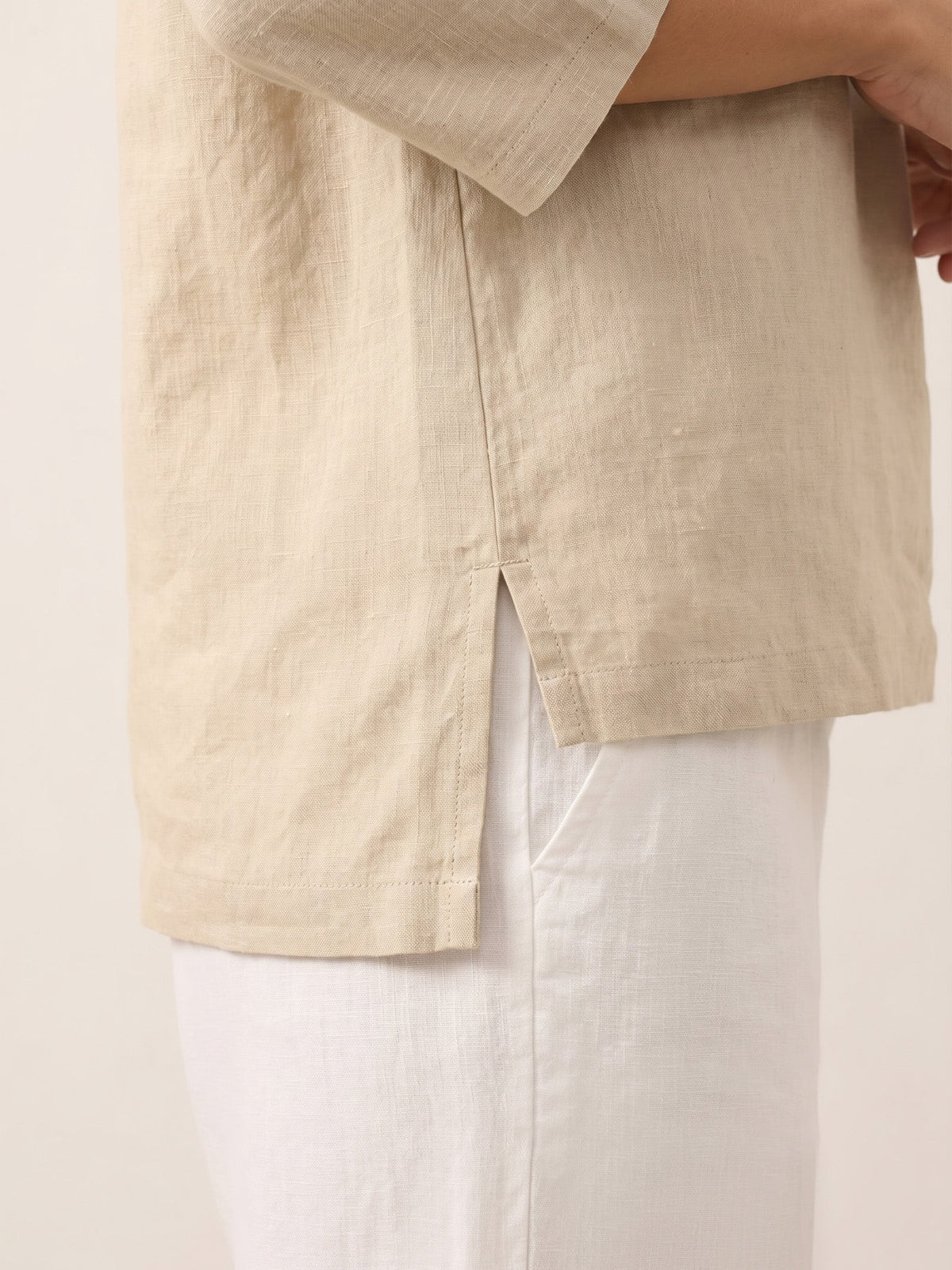 a person wearing a beige shirt
