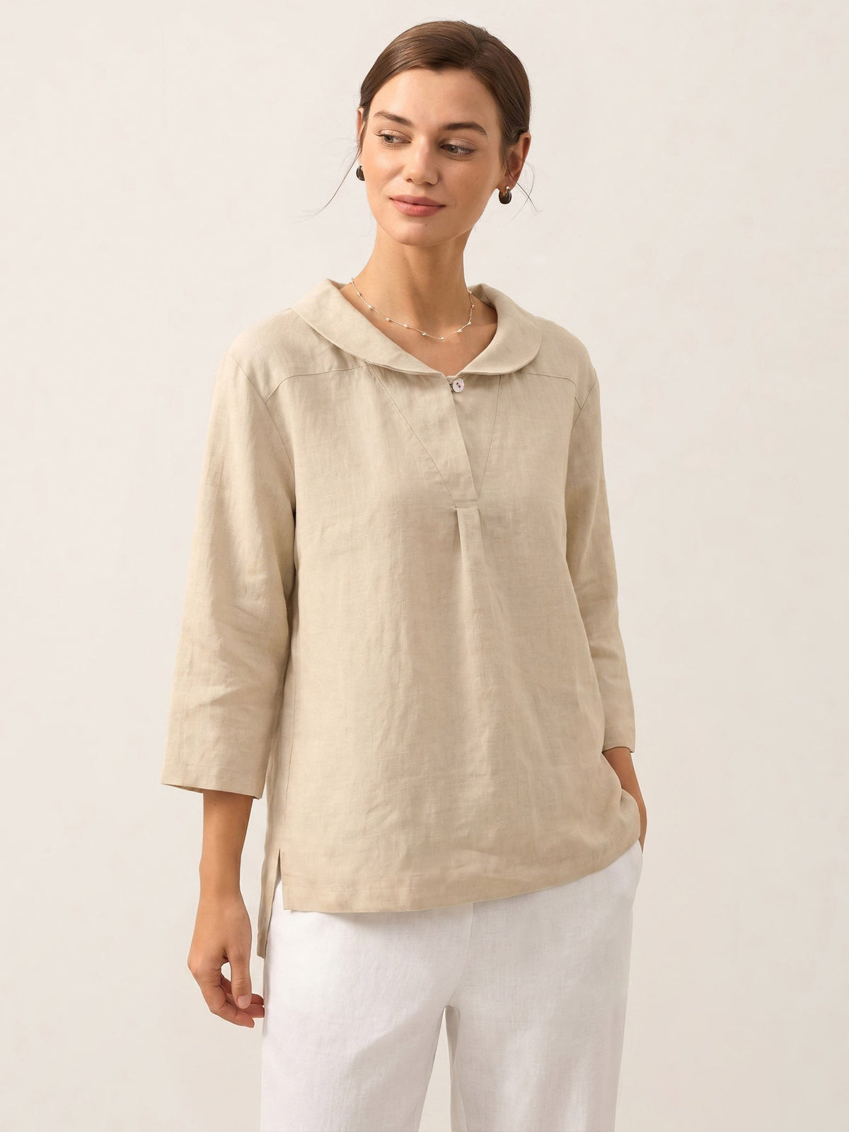 a woman in a beige shirt