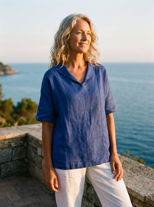 a woman standing on a ledge looking away from the camera
