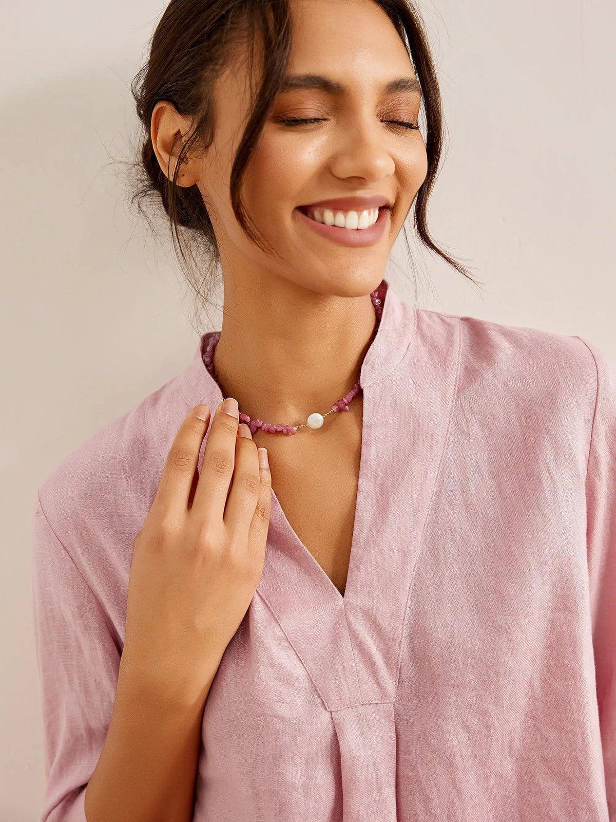 a woman smiling with her eyes closed