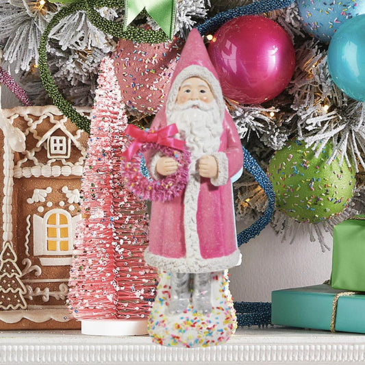 a figurine of a santa claus and a gingerbread house
