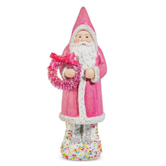 a statue of a santa claus holding a wreath