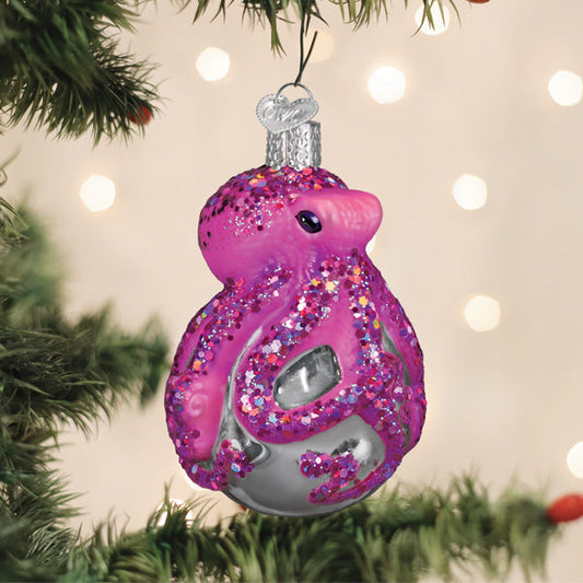 a pink and silver ornament from a tree