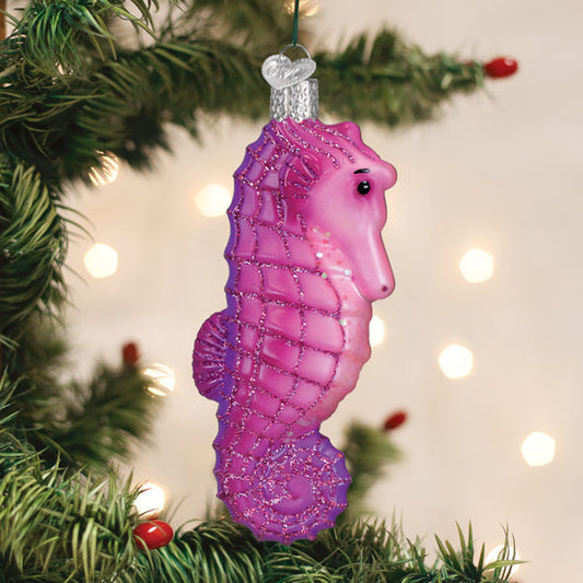 a purple seahorse ornament from a tree