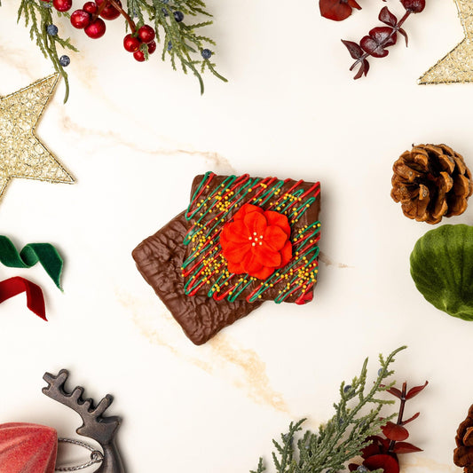 a brown square with a red flower and green leaves surrounded by decorations