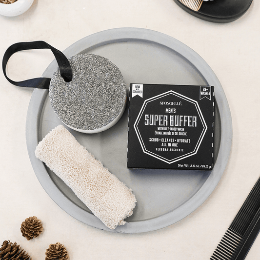 a round gray plate with a black box and a white sponge on it