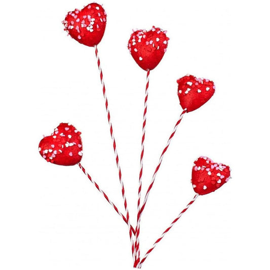 a group of red hearts on sticks