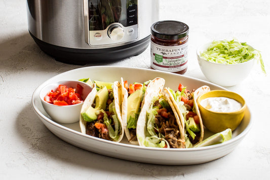 a plate of tacos and sauces