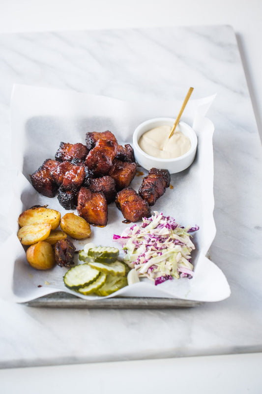 a plate of food with a sauce and pickles