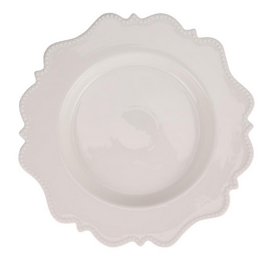 a white plate with a scalloped edge