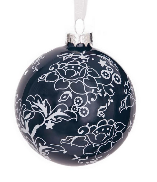 a black and white ornament with white flowers