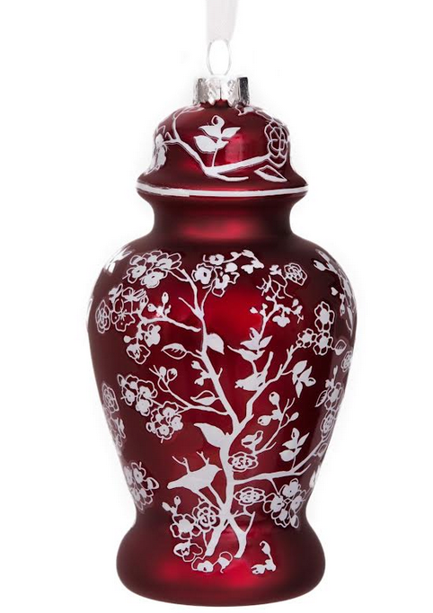 a red and white vase with a white design