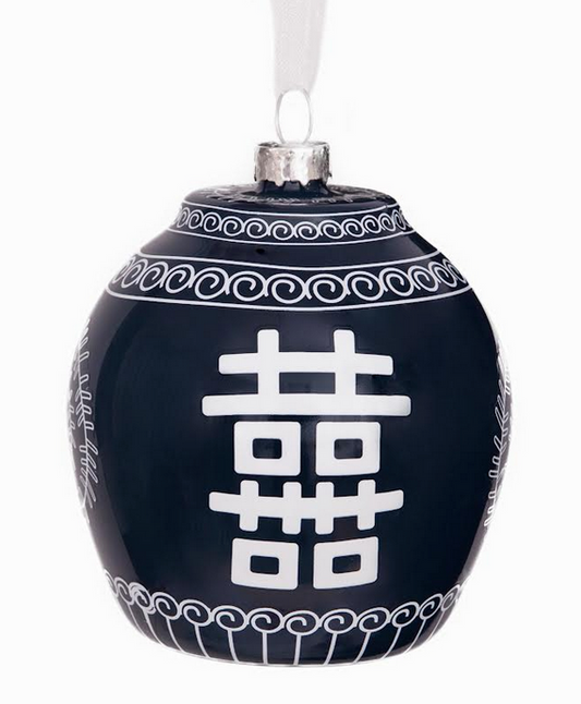 a black and white ornament with white text