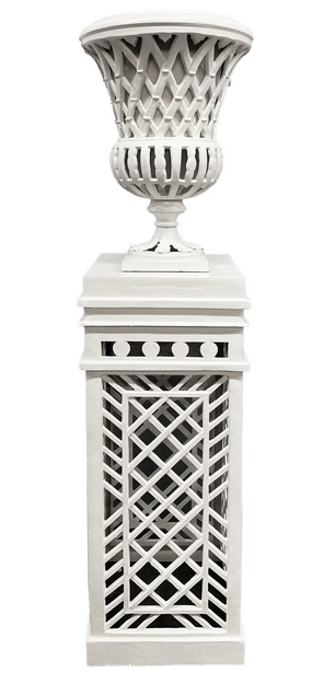 a white pedestal with a vase on top