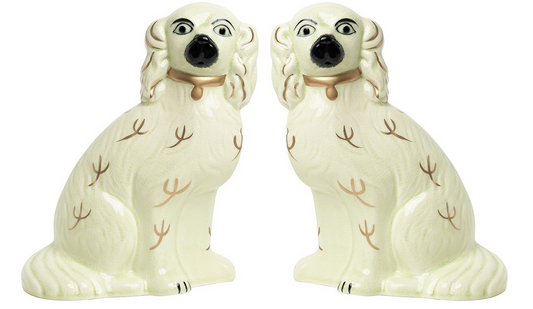 a pair of white dogs figurines