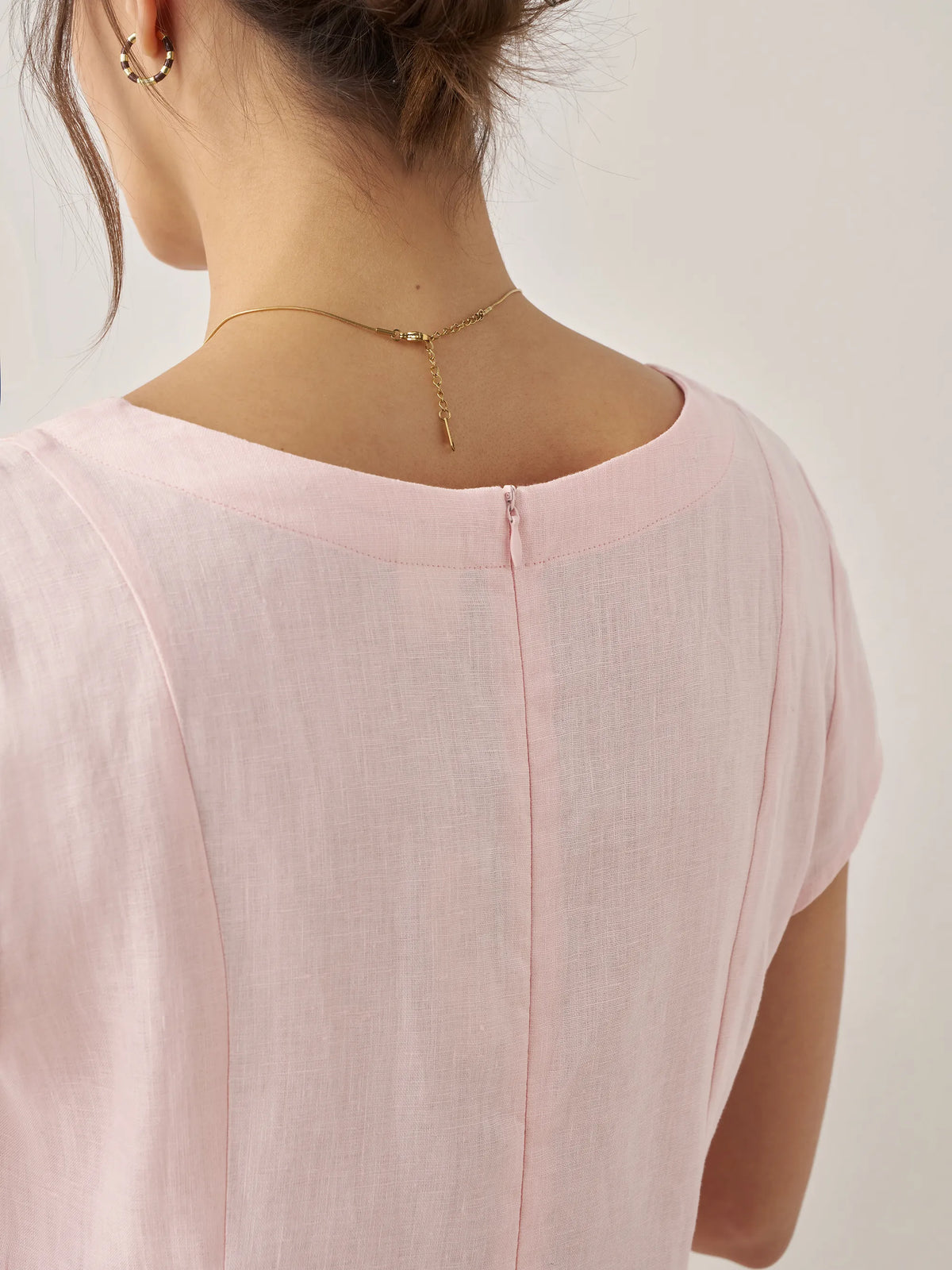 a woman wearing a necklace