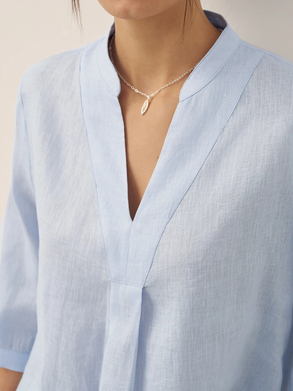 a woman wearing a necklace