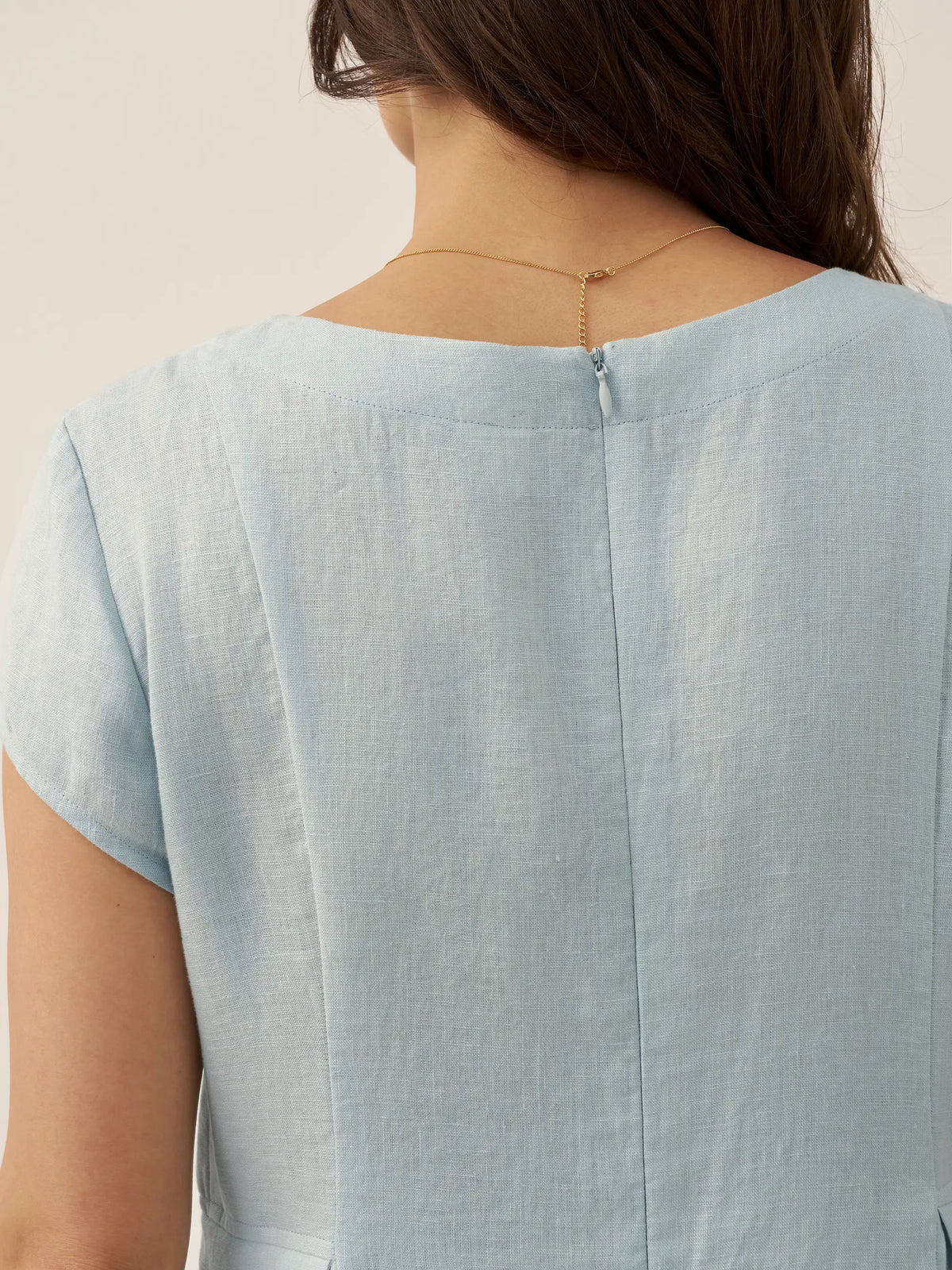 the back of a woman wearing a blue dress