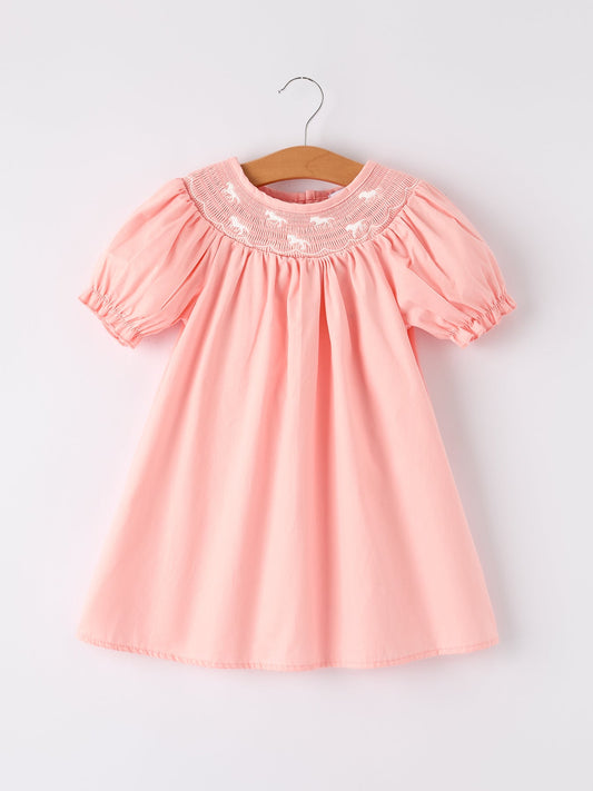 a pink dress on a swinger