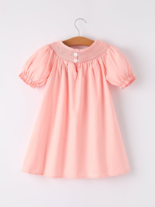 a pink dress on a swinger