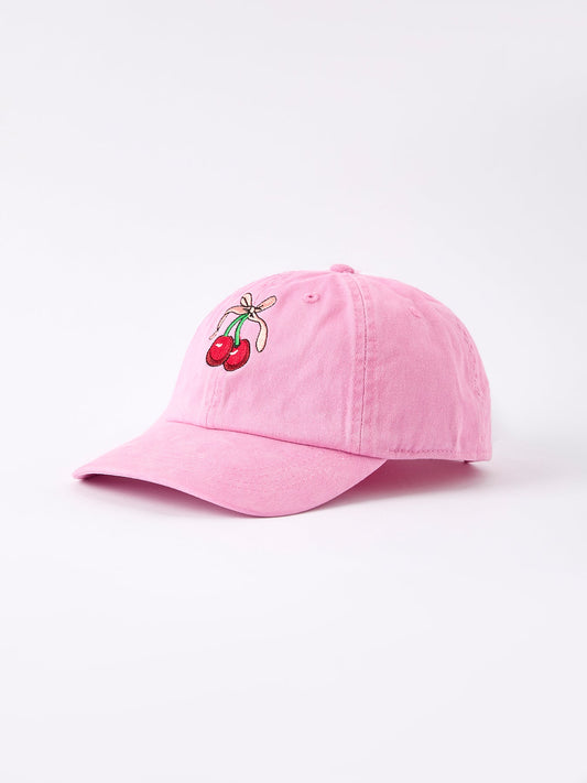 a pink hat with cherries on it