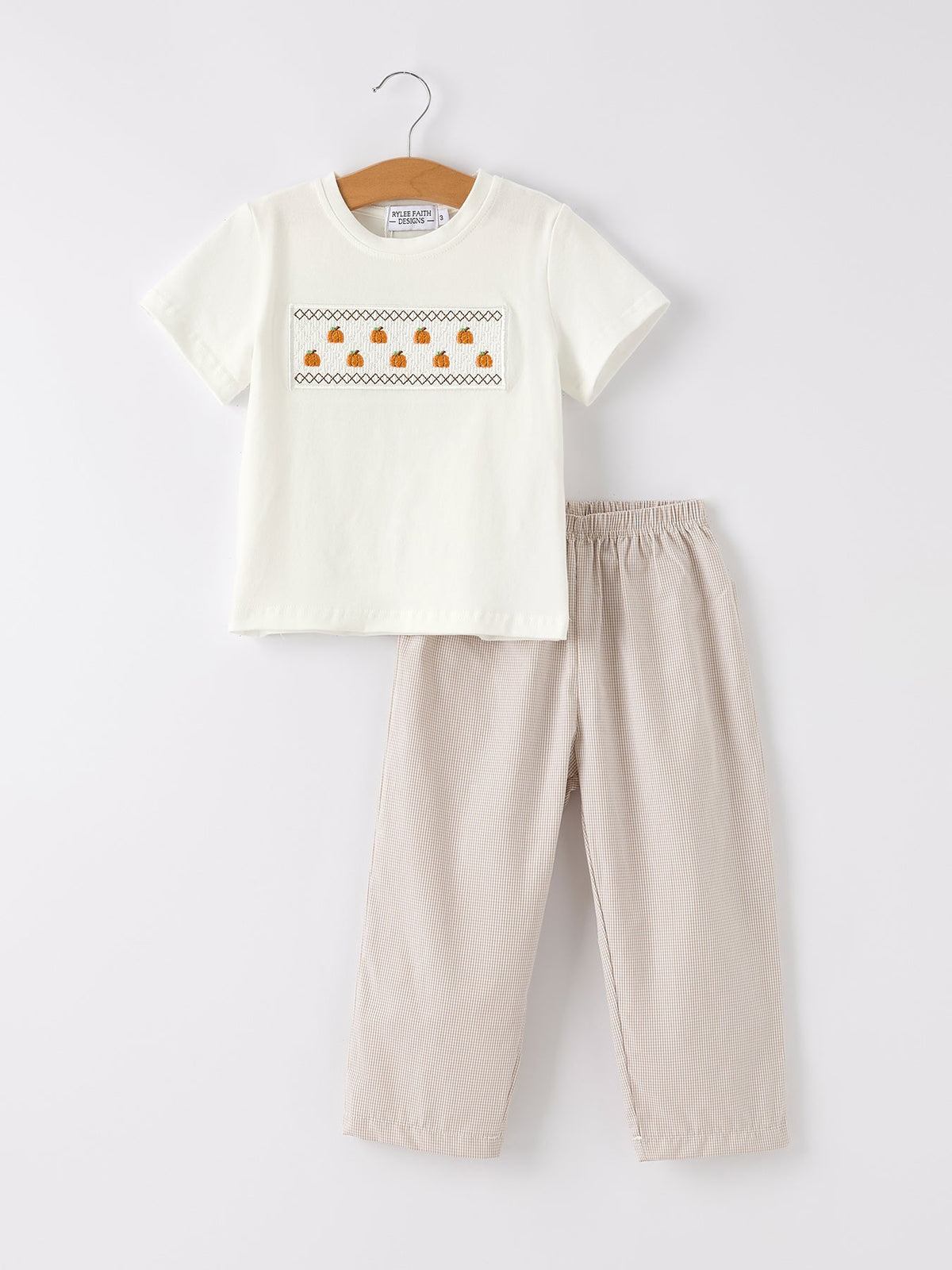 a white shirt and pants on a swinger