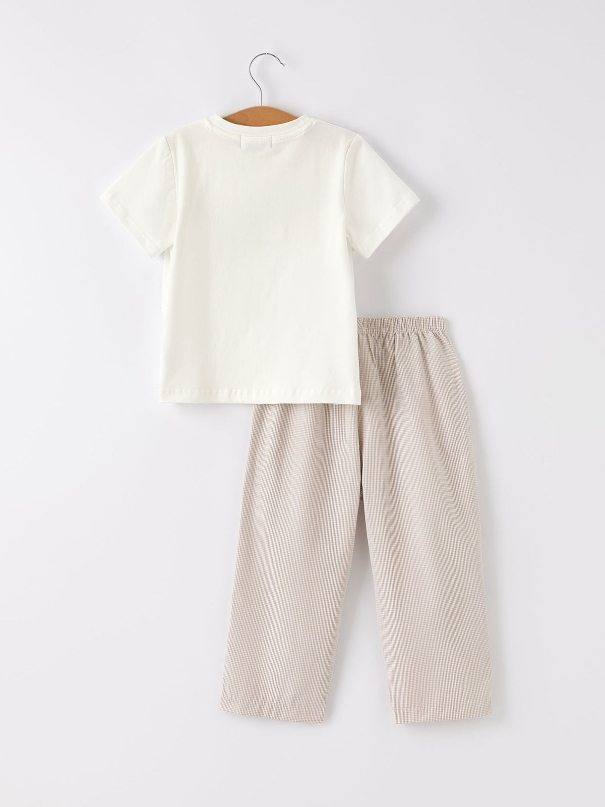 a white shirt and pants on a swinger