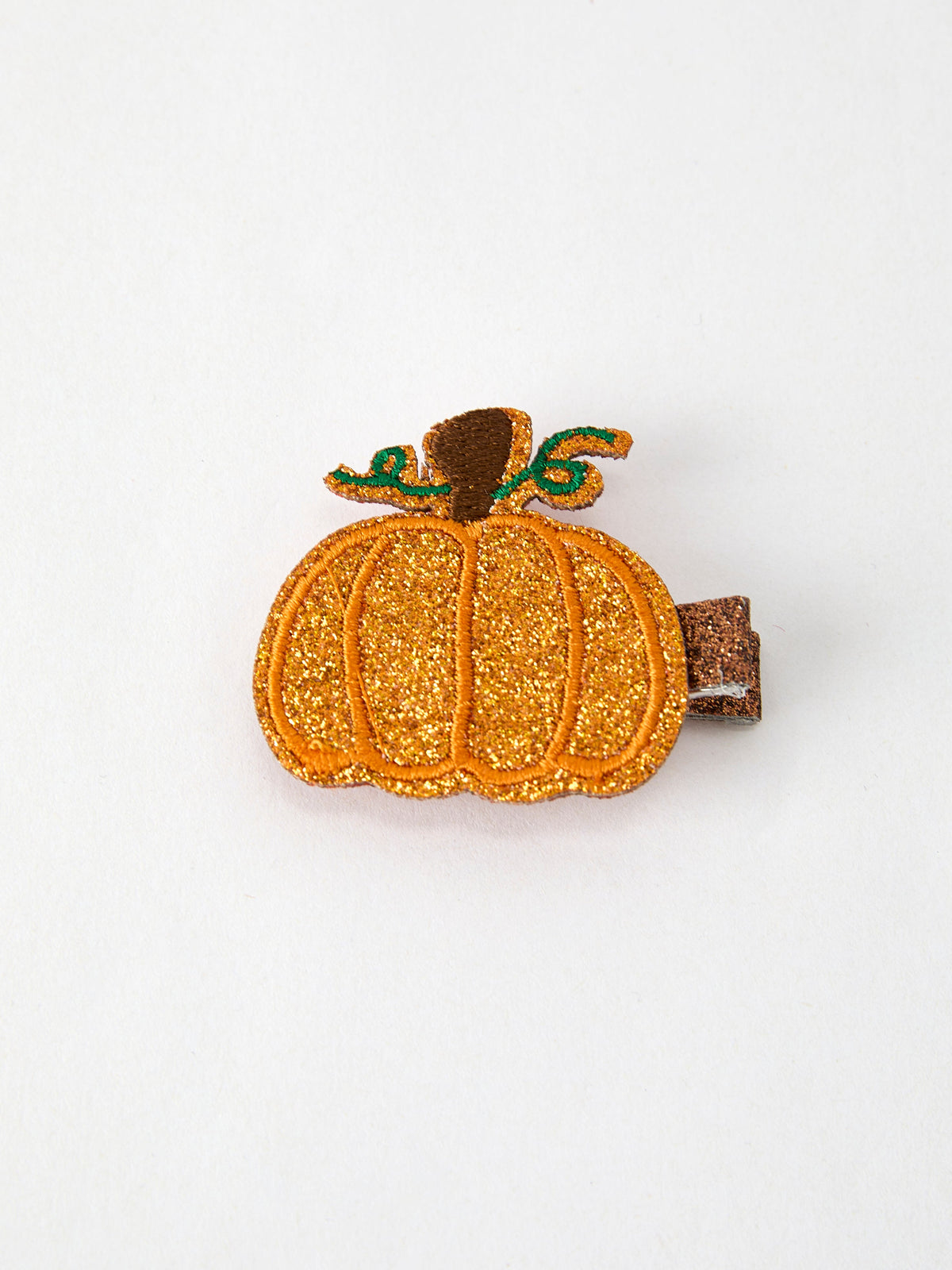 a small orange pumpkin hair clip