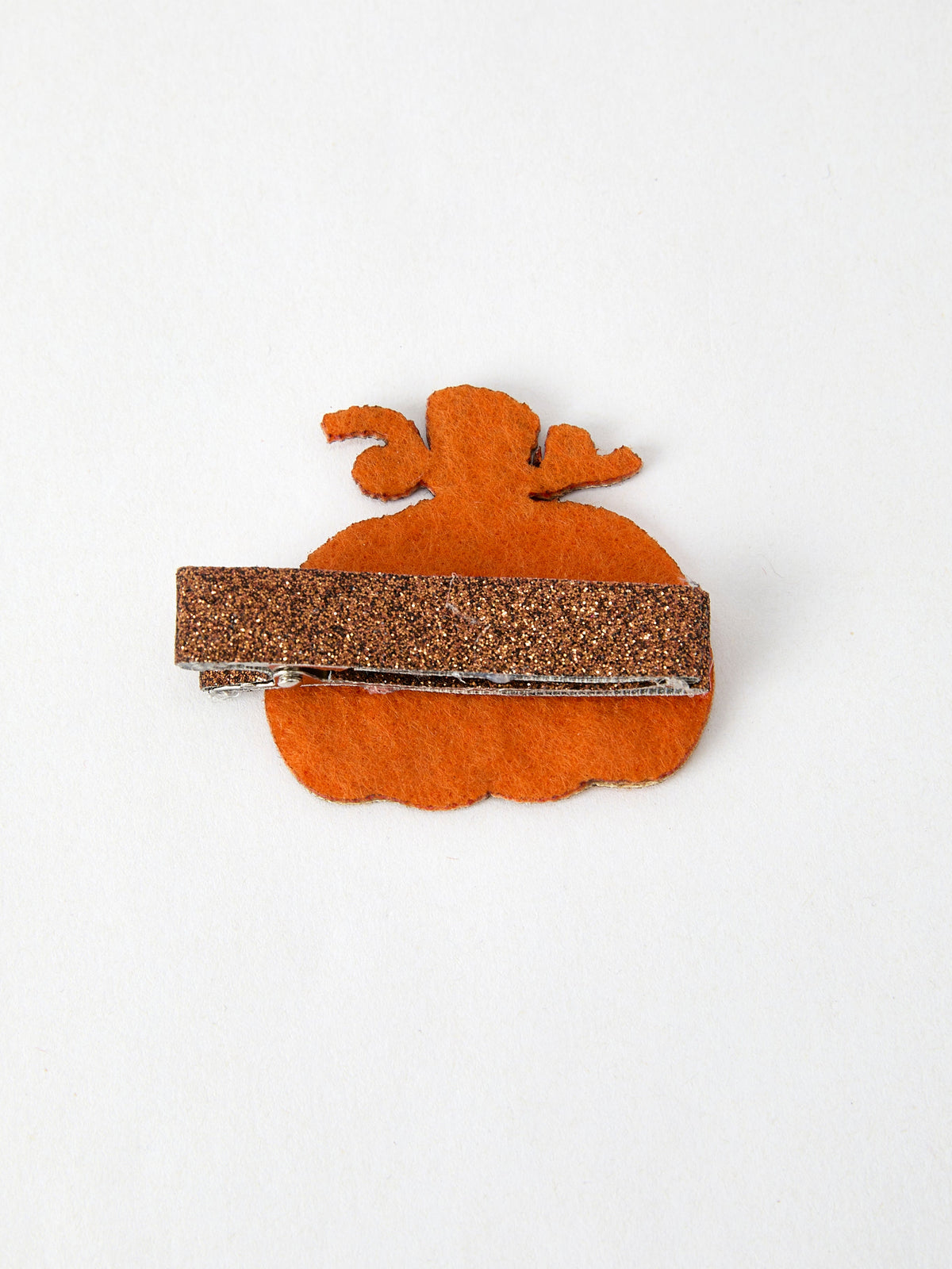 a hair clip with a glittery orange object