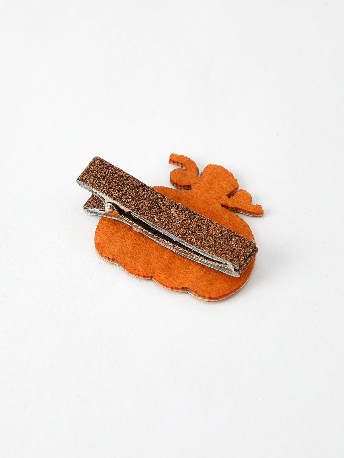 a brown hair clip with a brown object on it