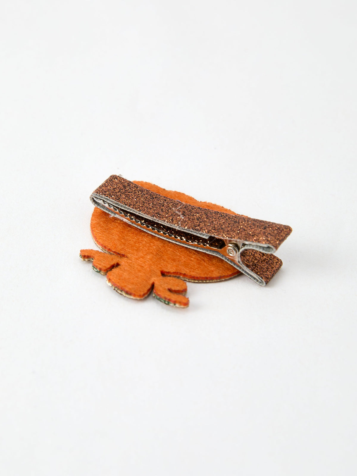a hair clip on a white surface