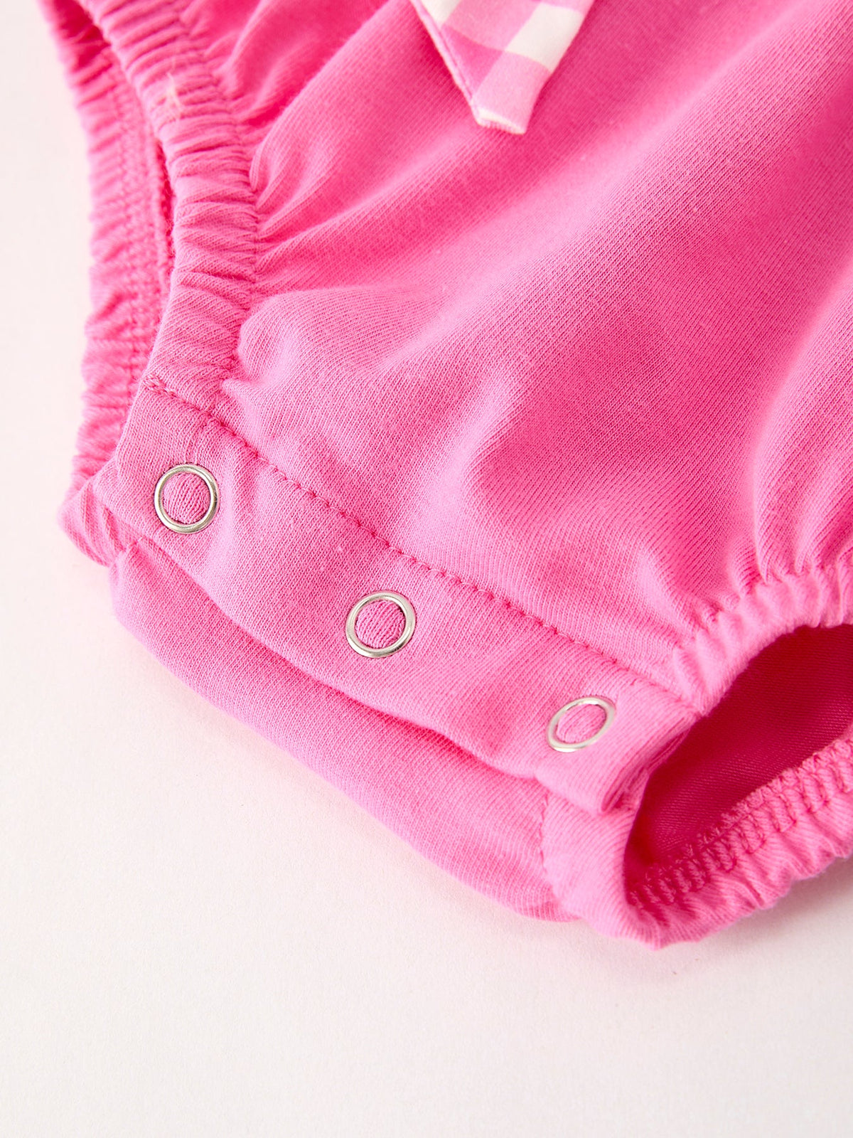 a pink baby shorts with three holes