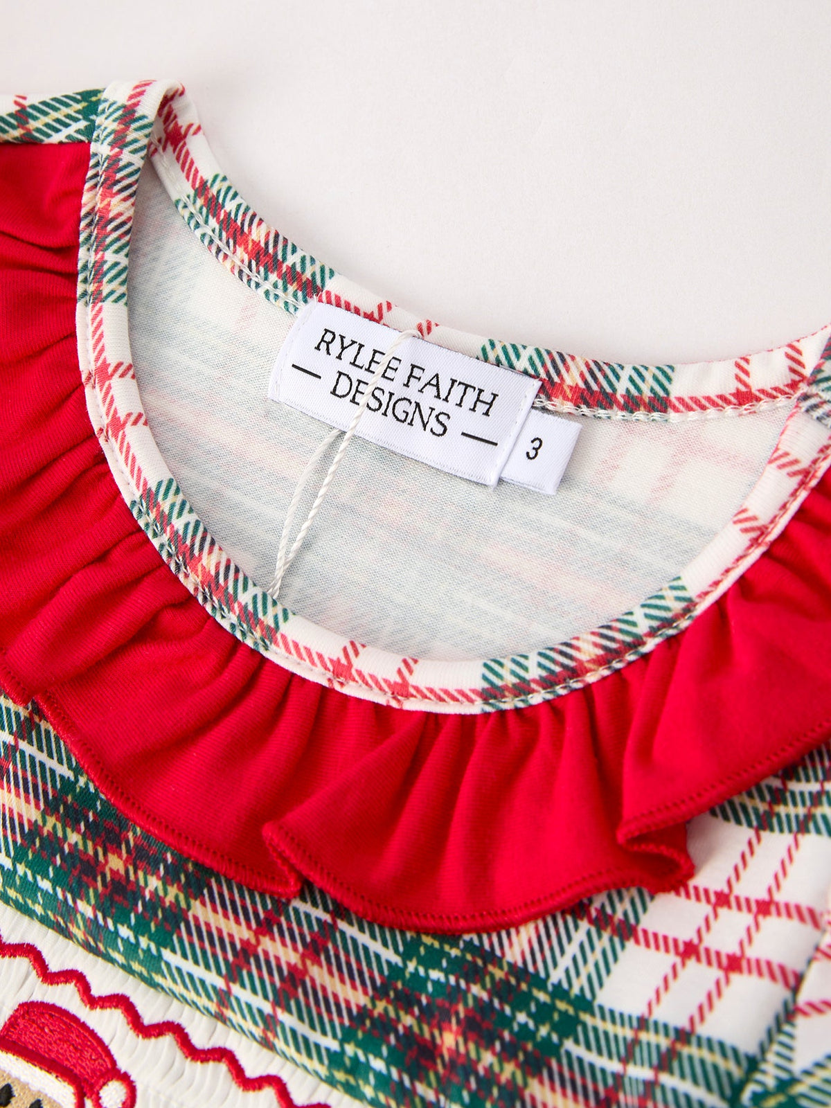 a close up of a red and white plaid shirt