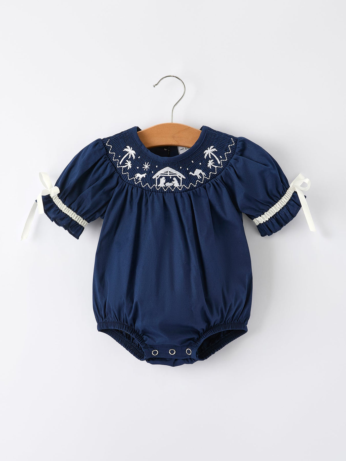 a blue baby romper on a swinger