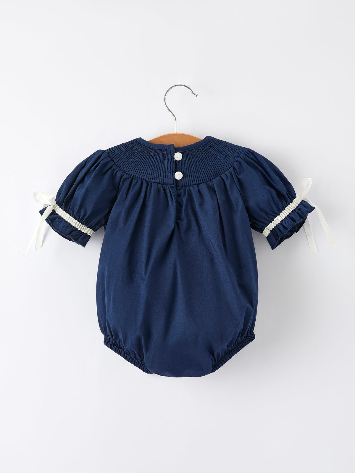 a blue baby romper on a swinger