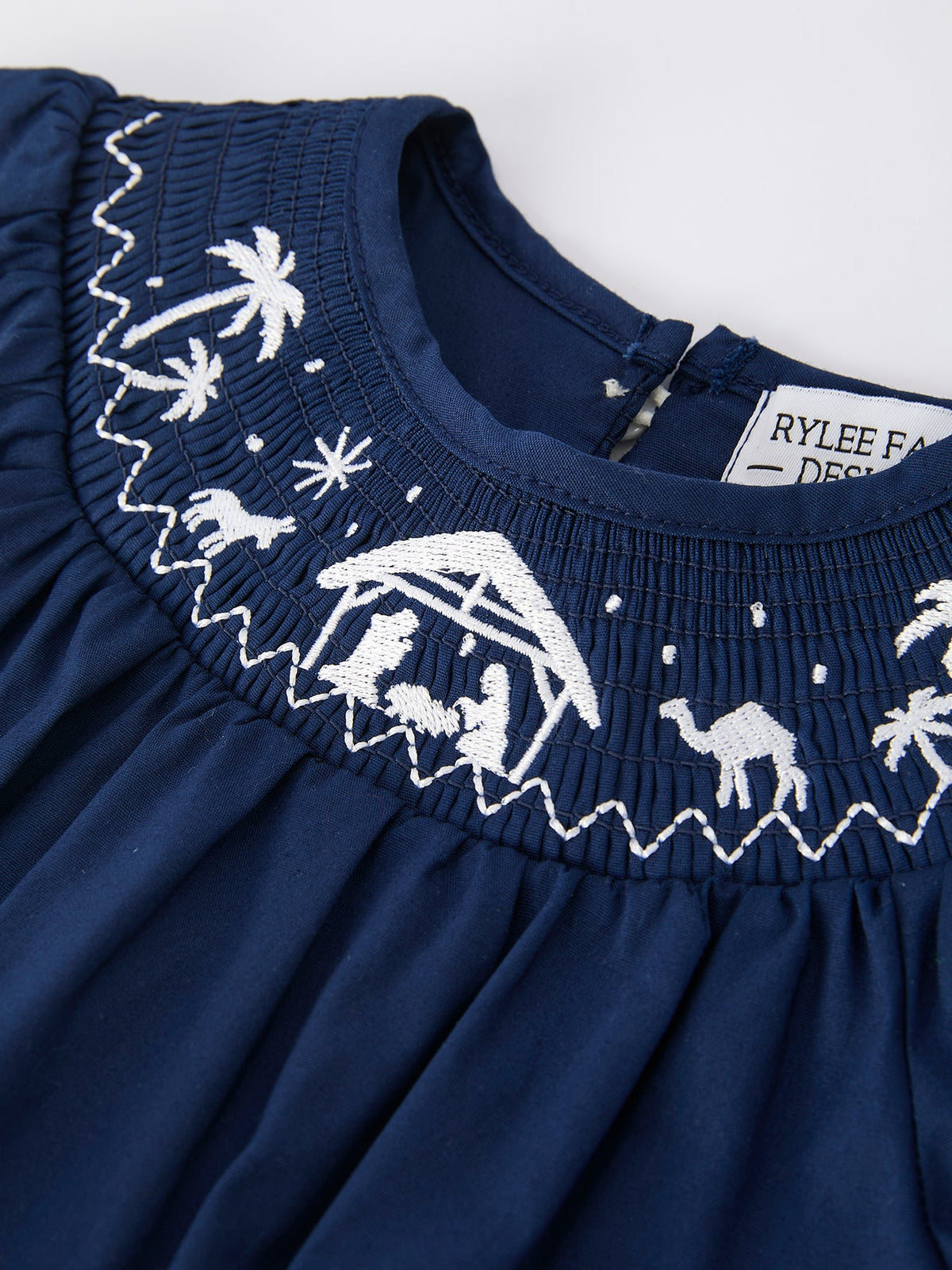 a blue dress with white embroidery