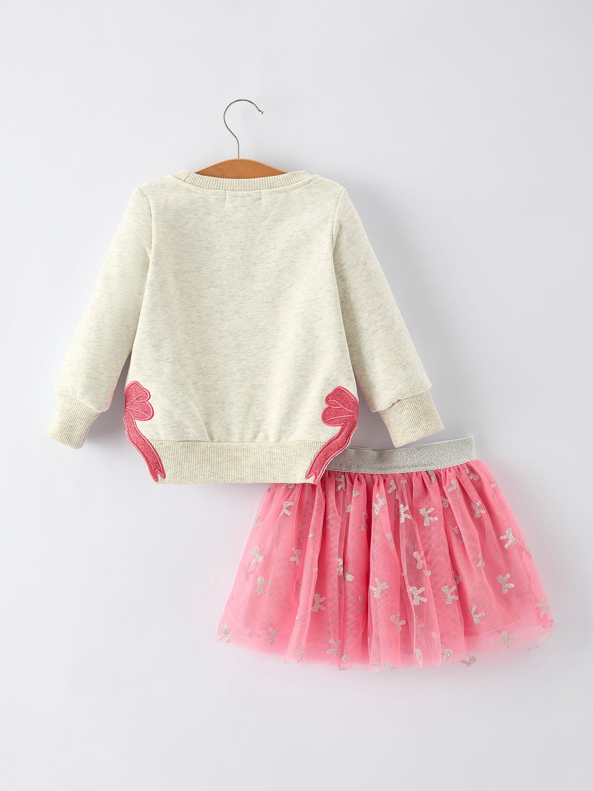 a white sweater and pink tutu