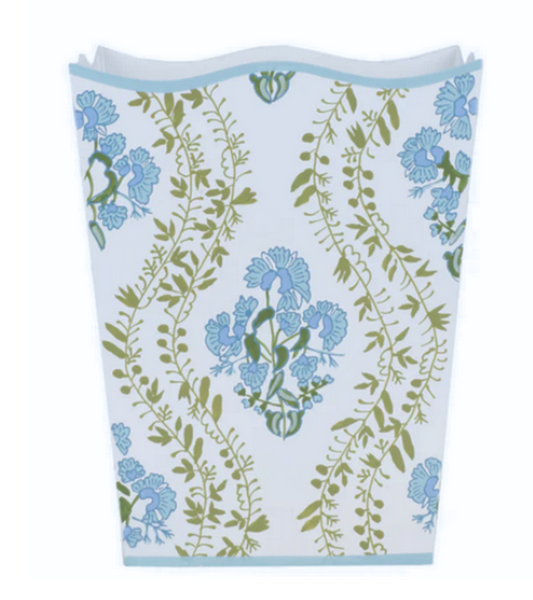 a white and blue vase with flowers