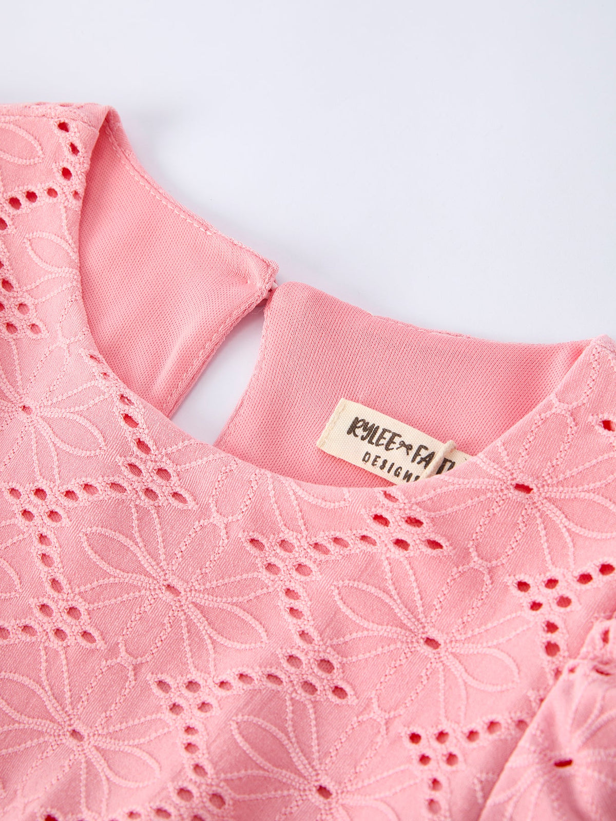 a pink shirt with a tag on it