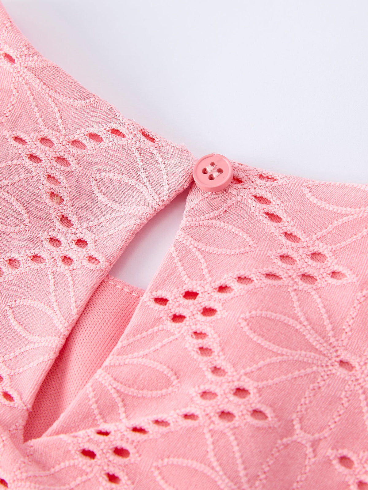 a pink shirt with a button