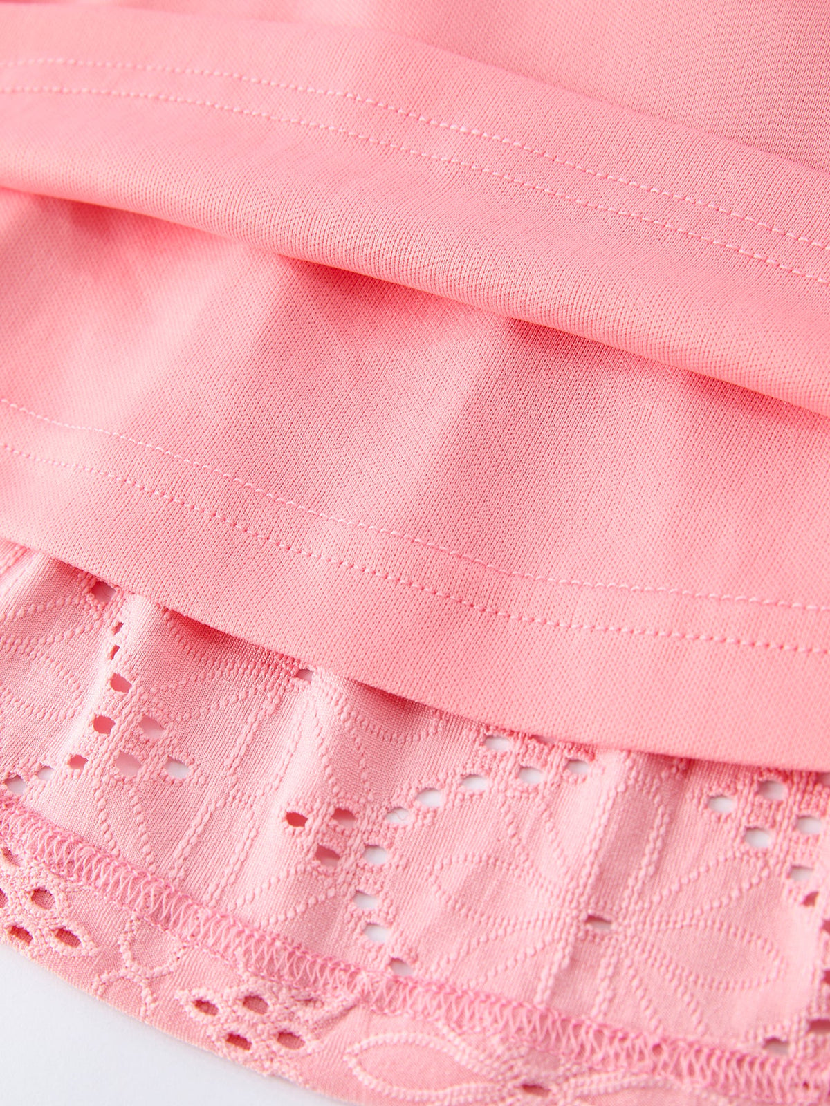 a pink fabric with a cut out edge