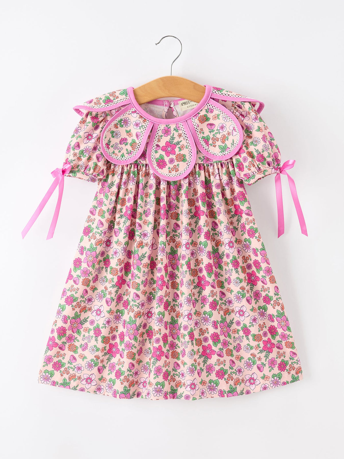 a pink and white dress with pink flowers on it