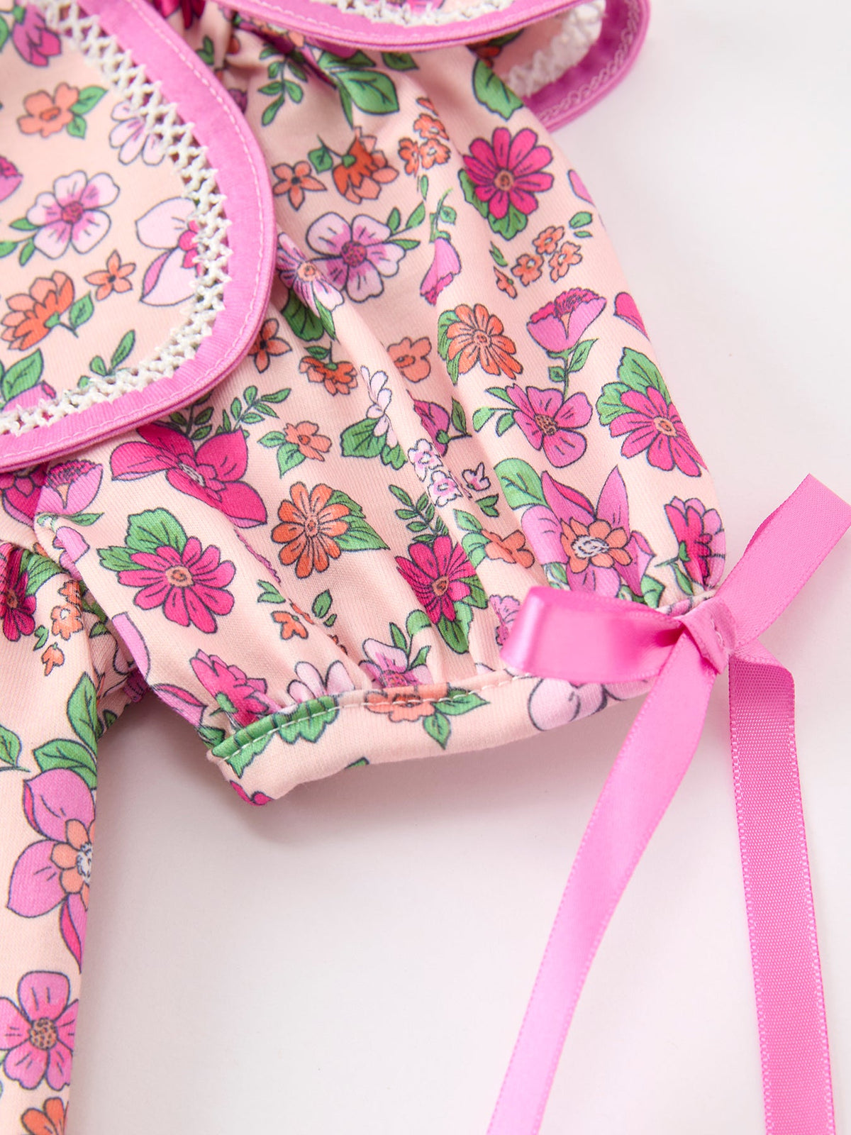 a pink and white floral pattern with a pink bow