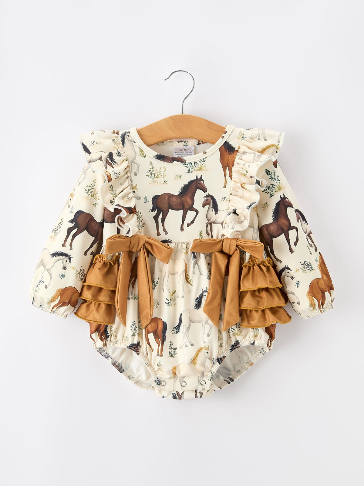 a baby romper with horses on it