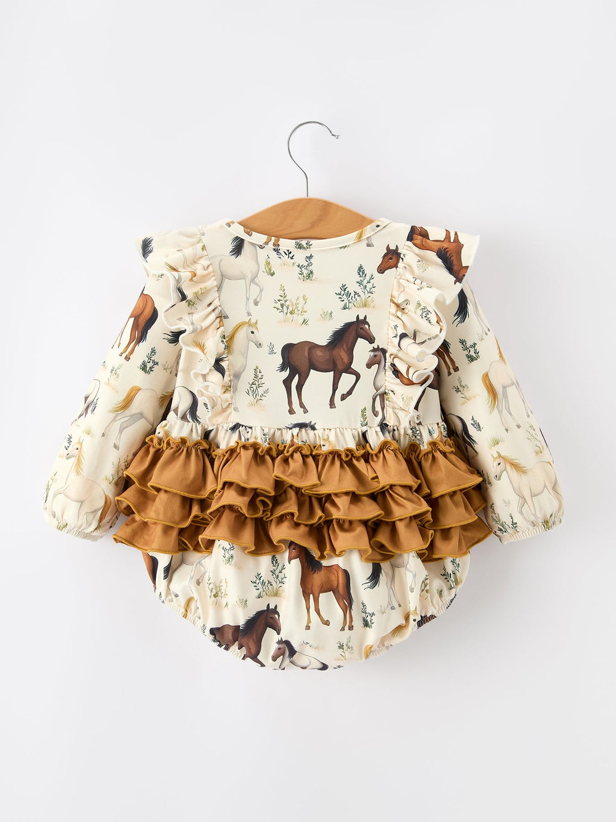 a baby romper with horses on it
