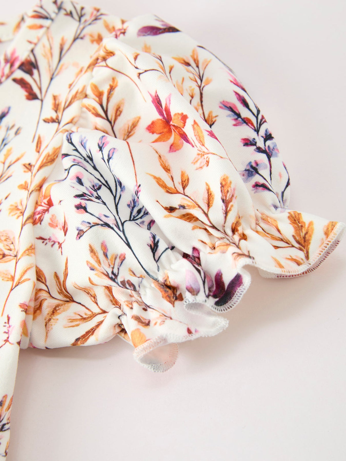 a white fabric with colorful flowers on it