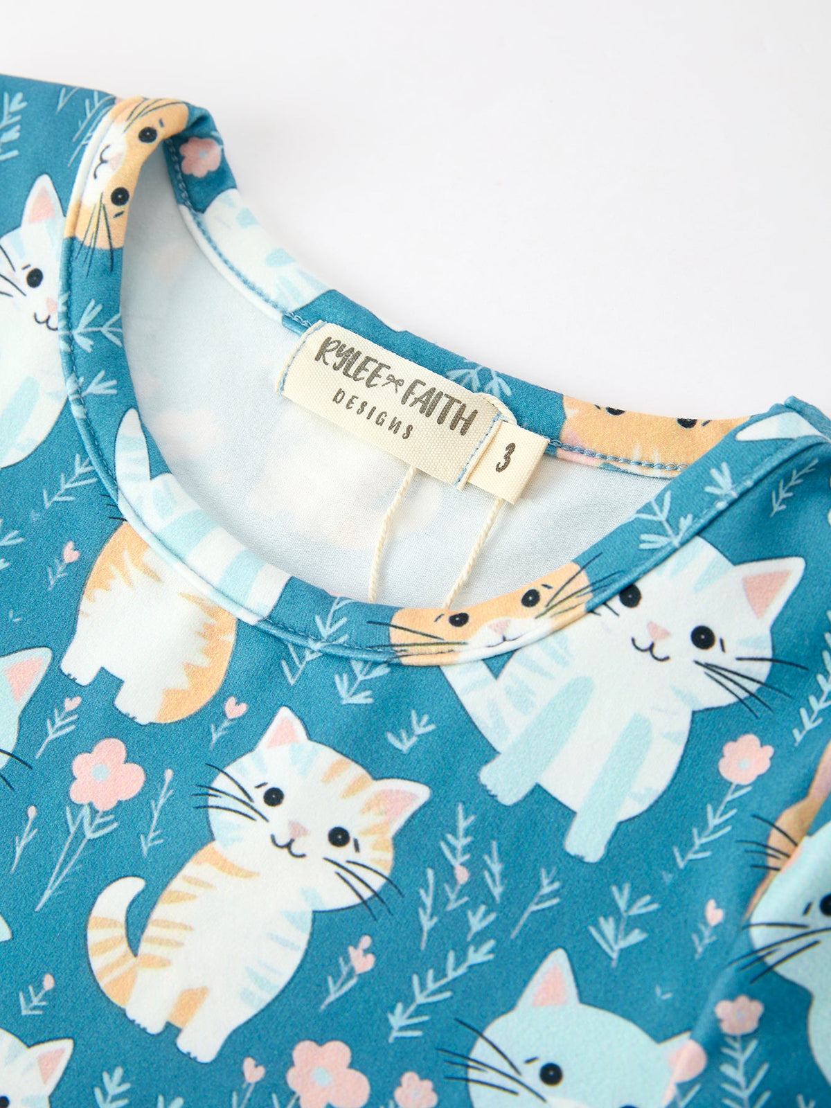 a blue shirt with cats on it